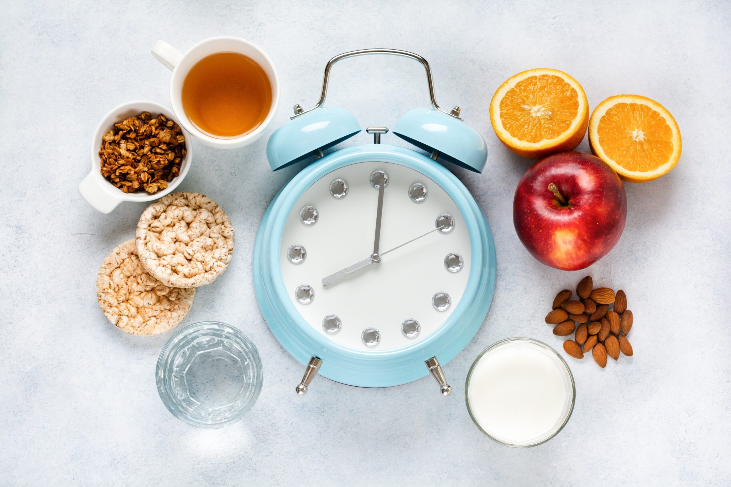 clock and food, referring to time restricted eating in intermittent fasting